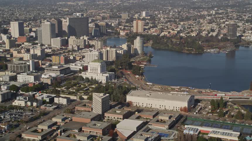 Aerial panorama of a metropolis with skyscrapers and urban areas with a lake in the city center