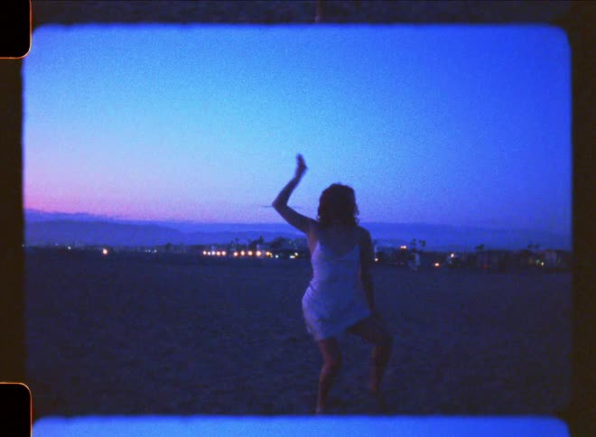A woman is dancing on the beach