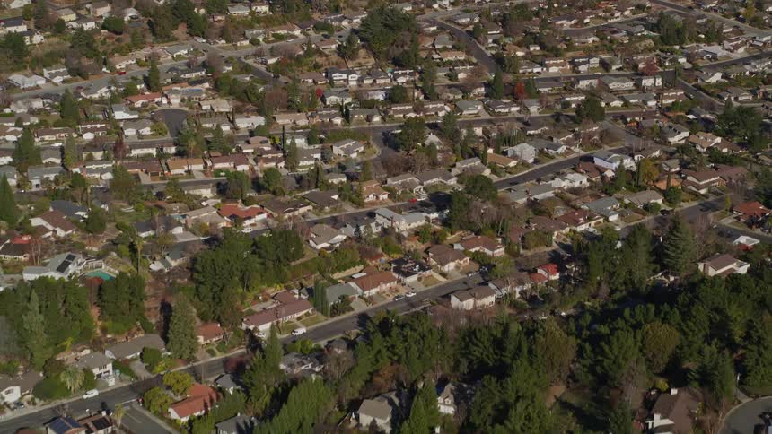 Aerial panorama of a residential neighborhood with intersections and trees