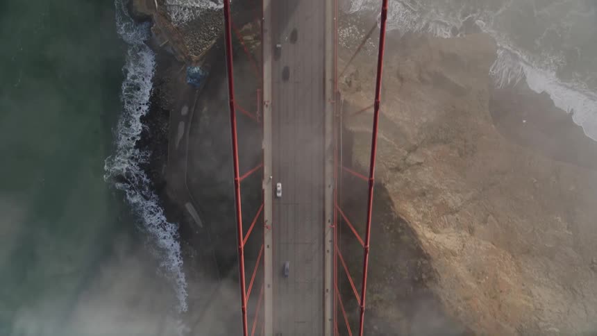 Aerial view of a street leading to the golden gate bridge during the day with vehicle traffic