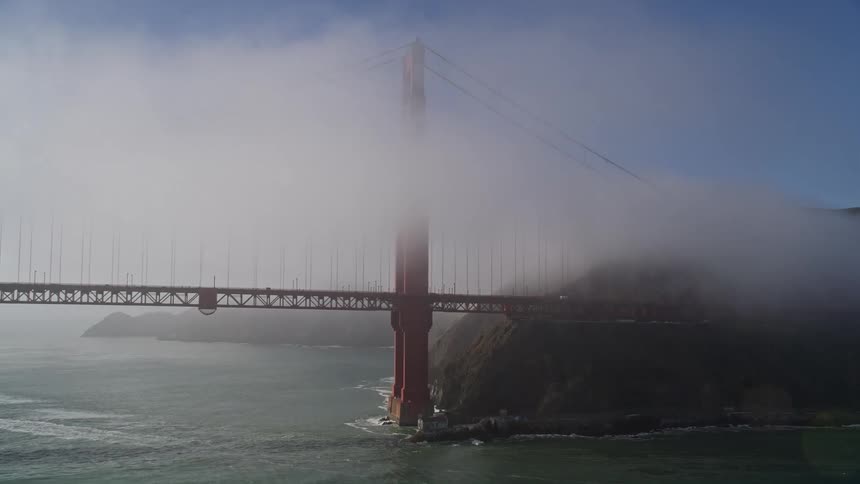 Golden gate bridge with fog and vehicle traffic during the day