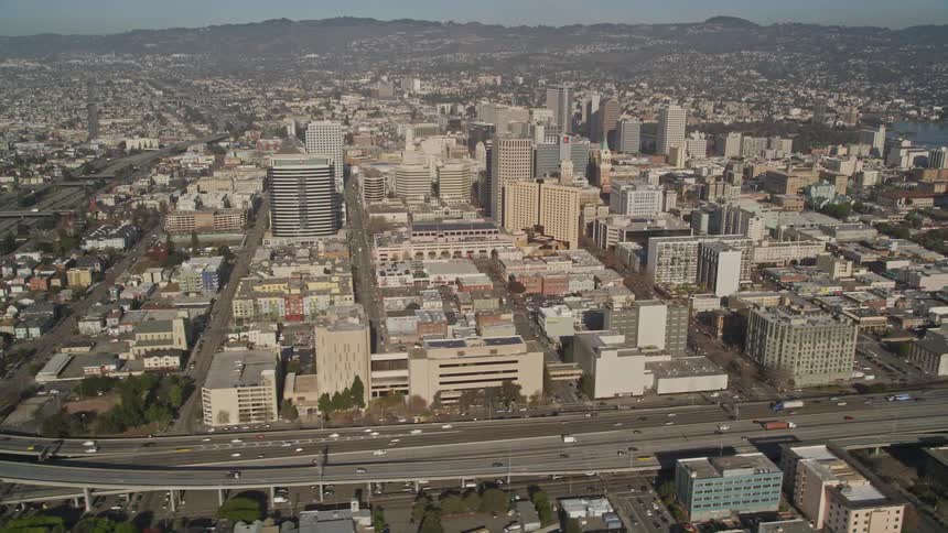 Aerial panorama of a metropolis with a skyscraper and urban areas during a day with a central highway with vehicle traffic
