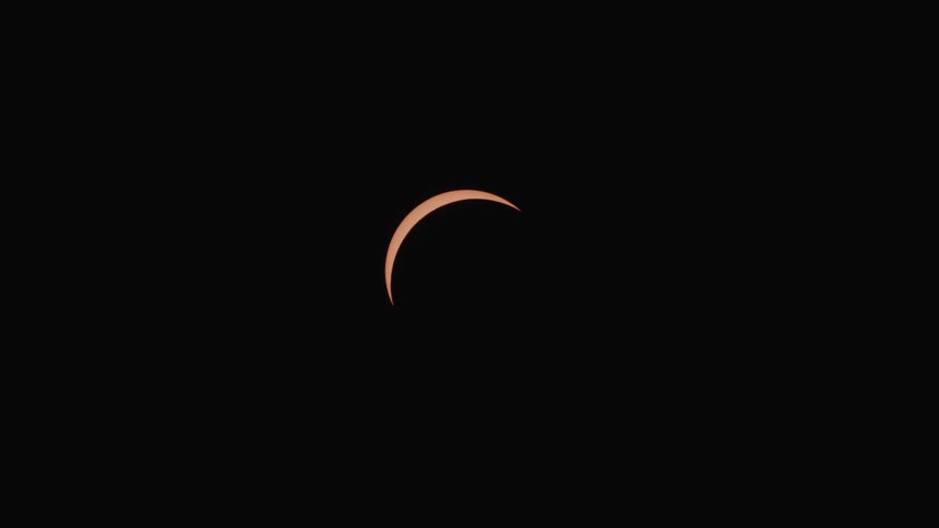 View of a dark sky with the moon in the process of eclipse