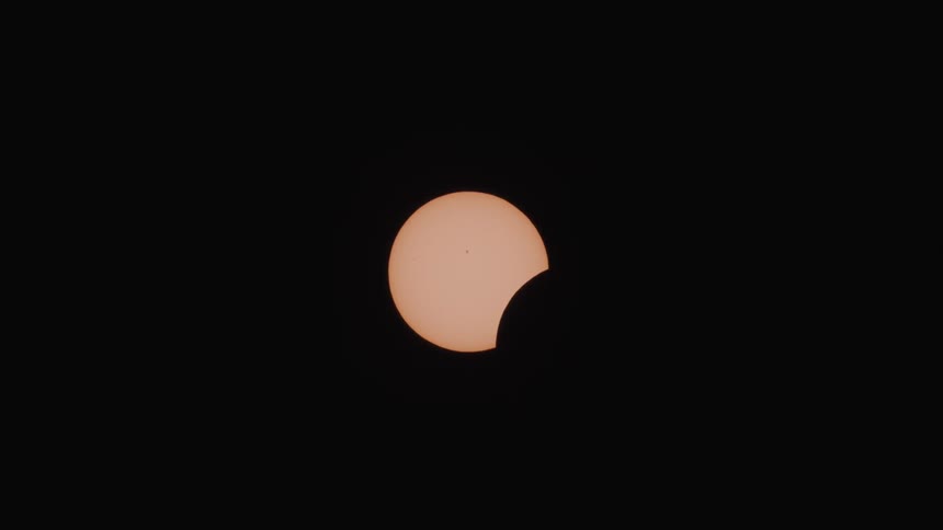 The moon begins to eclipse the sun