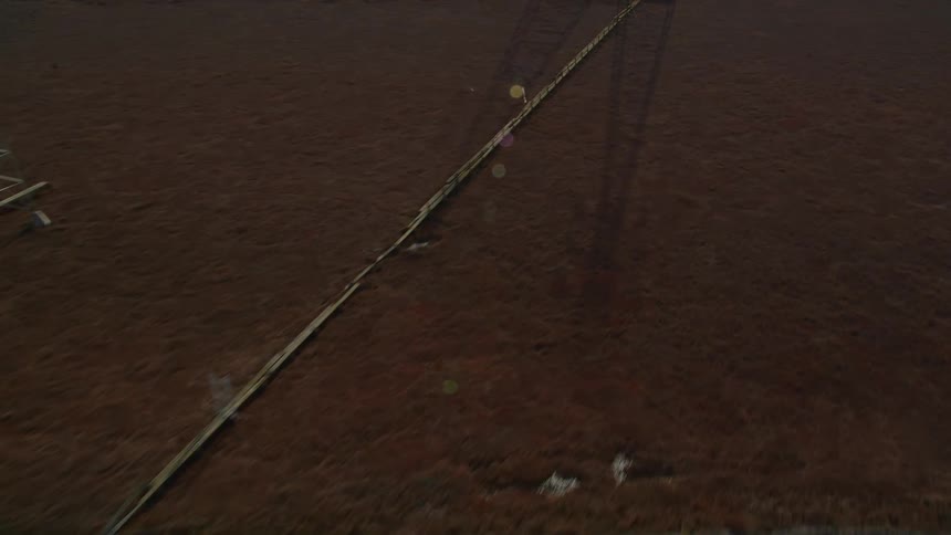 Aerial view of pipes in water reservoirs with power transmission towers