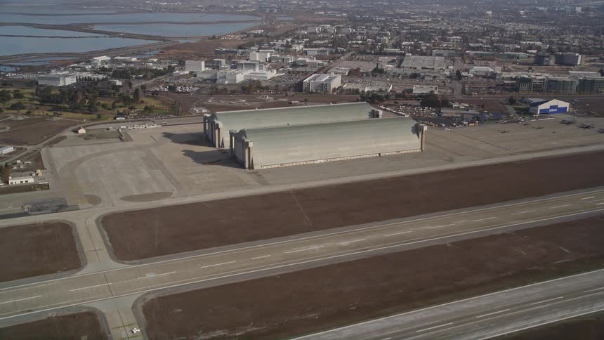 Aerial panorama of runways at an airport and an urban city on the horizon