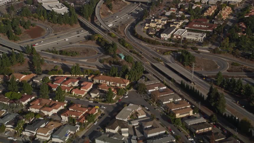 Aerial panorama of an urban city with intersections and overpasses with vehicle traffic