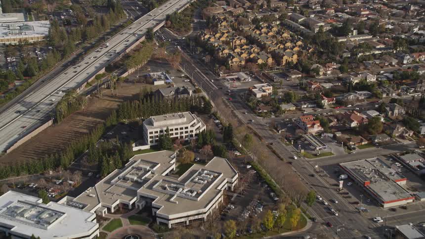 Aerial scenery of a residential neighborhood with highways with vehicle traffic