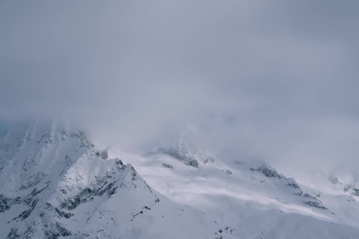 Mountain range covered by snow on a snowy day