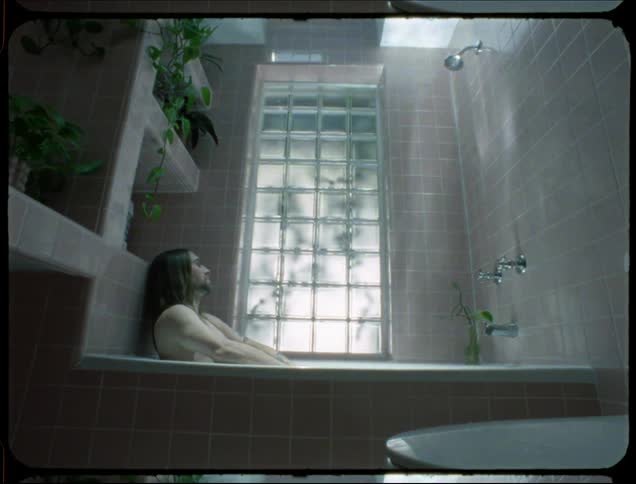 Man lying in a bathtub during the day