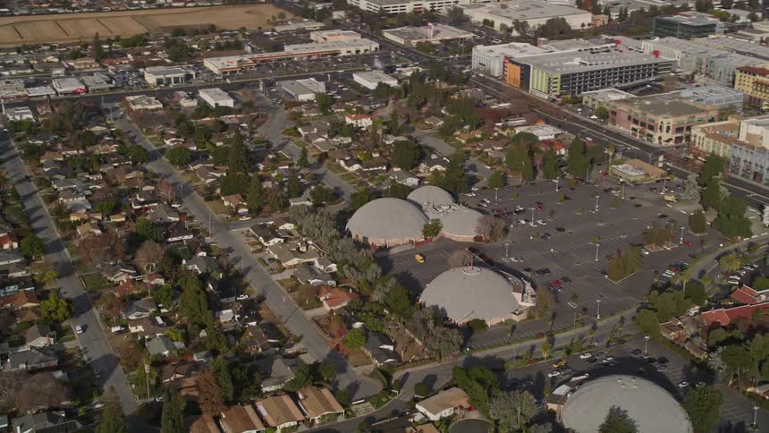 The parking lot is near the rows of homes
