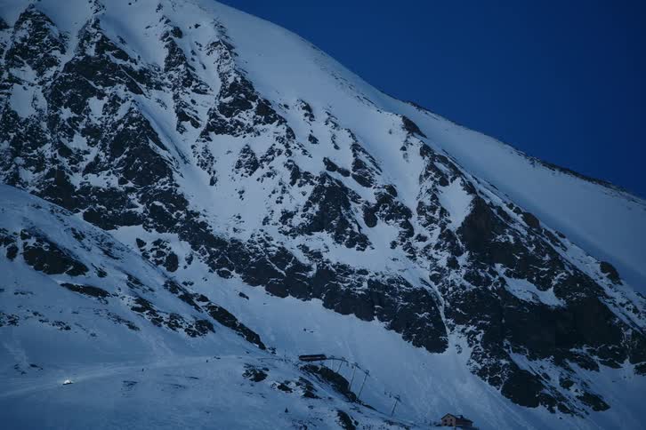 Scenery of mountain ranges covered by snow with dark blue sky