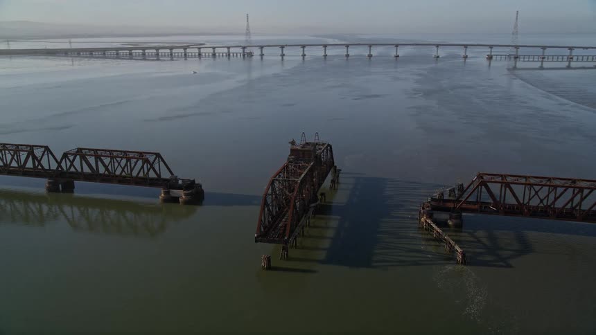 Aerial panorama of bridges over the sea with one of them open for passage
