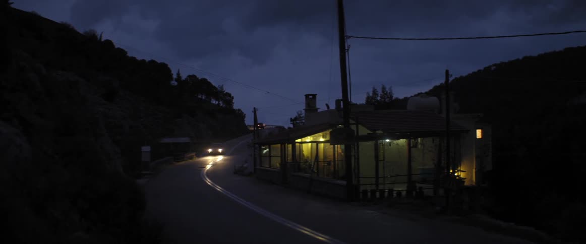 Cars drive on a road at night