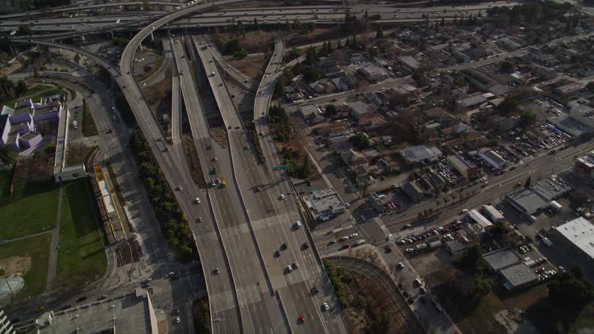 Aerial panorama of a metropolitan city with urban areas and highways and intersections with vehicle traffic