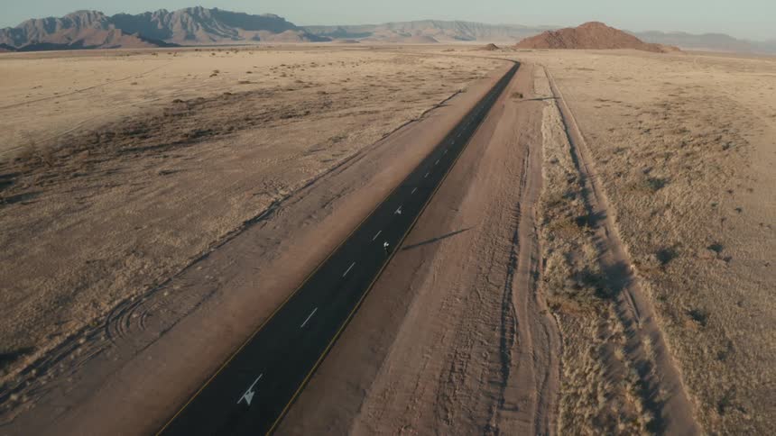 A person is riding their bike down the desert highway
