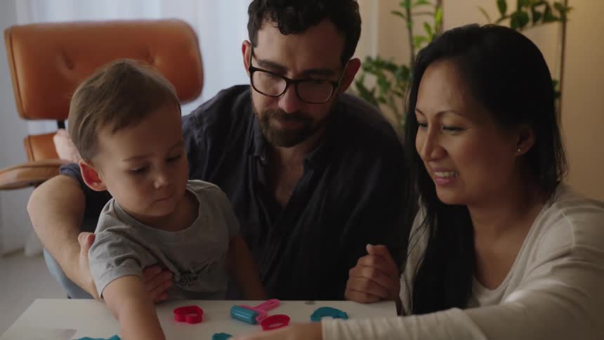 Parents show their son toys