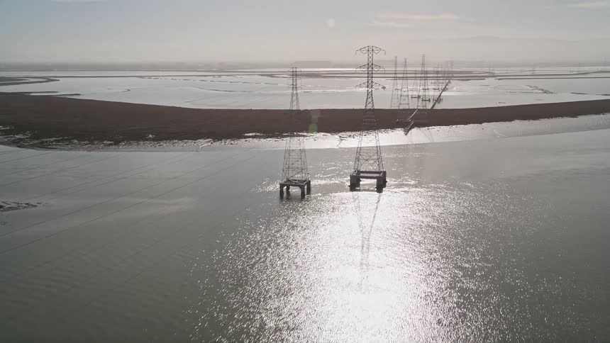 Panorama of a power plant with water reservoirs and electricity transmission towers