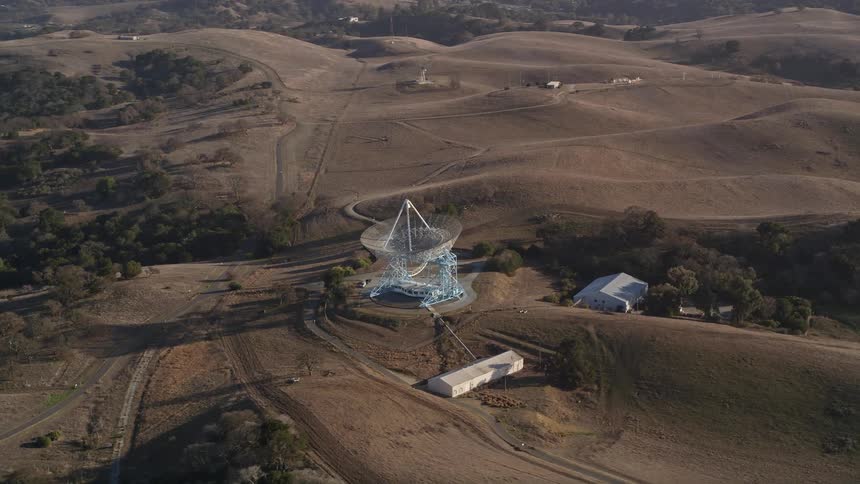 Aerial panorama of an antenna on a plateau on a hill with vegetation around it