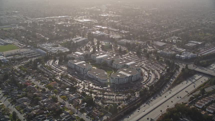 Aerial panorama of residential neighborhoods urban buildings and highways with vehicle traffic during the day