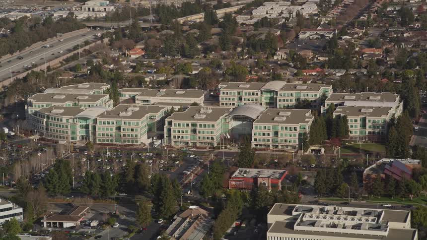 Aerial panorama of a city with residential buildings and houses and intersections with vehicle traffic during the day