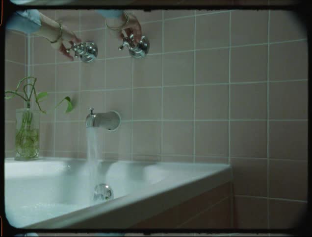A clip of a person switching on a tap