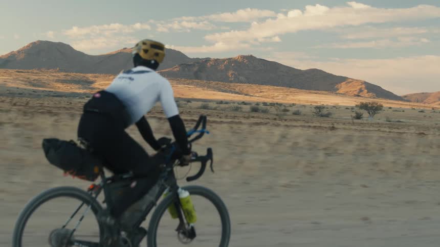 A man looks over the desert as he cycles