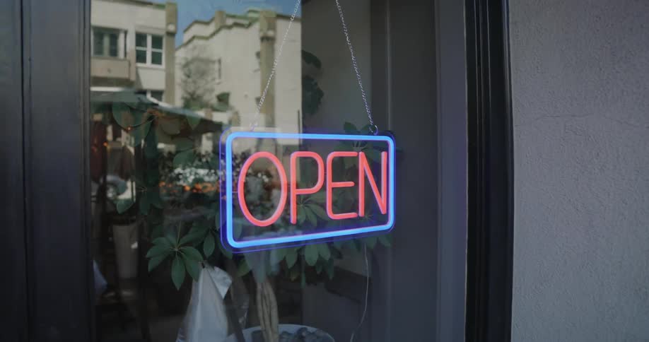 An employee of a store opens for business
