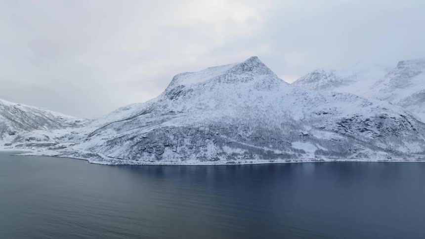 Snow covered mountains landscape by the sea