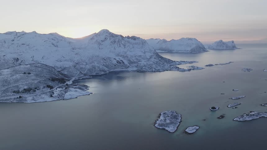 Snow and ice cover mountains and islands in a coastal area