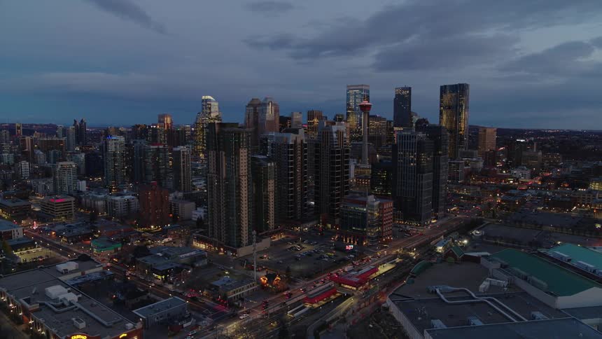 Aerial panorama of night sky overlooking downtown skyscrapers and vehicular traffic
