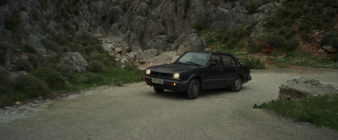 A car drives on a rural road