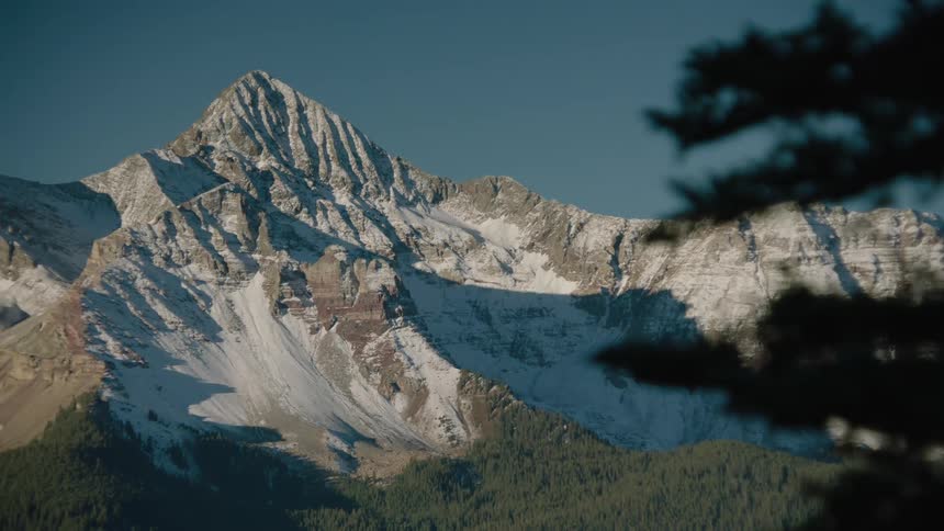 Landscape with mountain ranges and snowcovered cliffs meet the cloudless blue sky