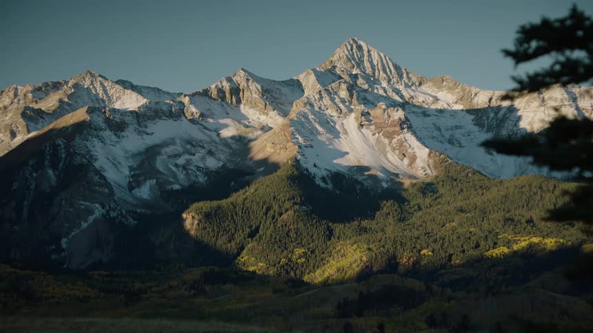 Landscape of the day dawning over the greenish and snowy mountains
