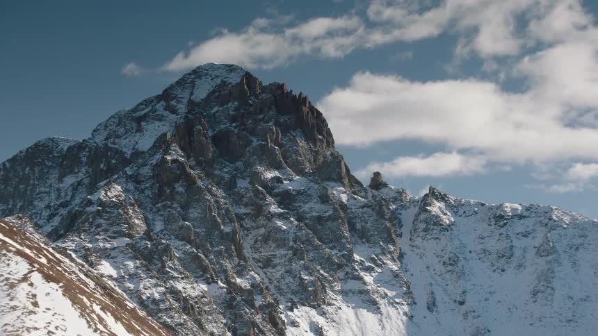 Mountain range with erosion and erosion covered by snow
