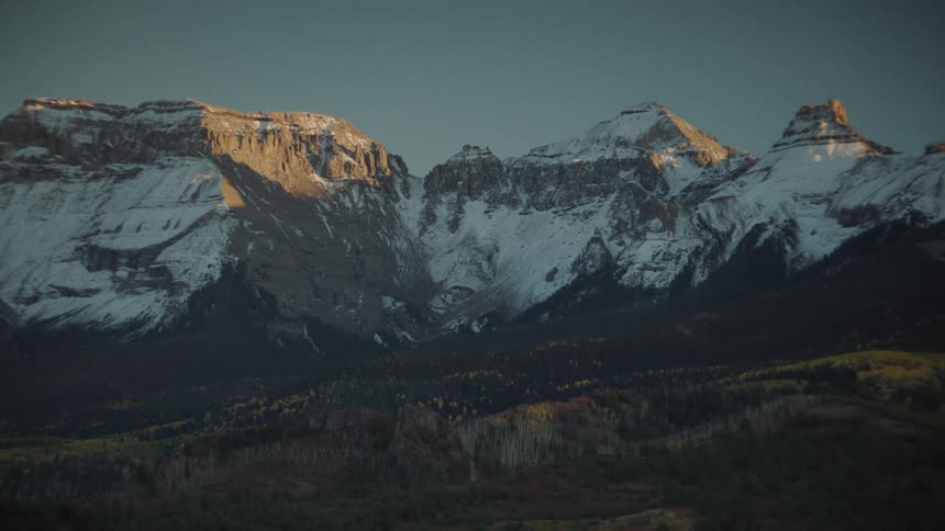 Natural wooded landscape with mountains on the horizon with snow on a morning