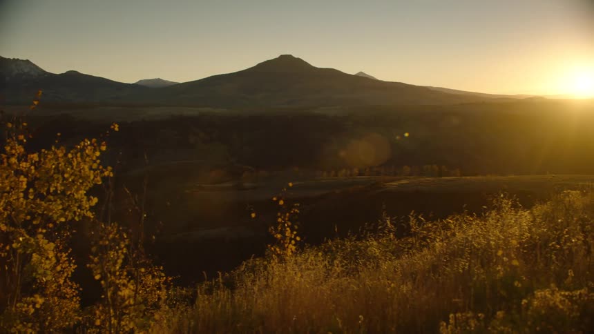 Natural landscape with the silhouette of mountains and the golden dawn sun
