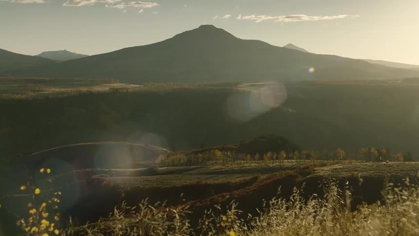 Grasslands give way to a large mountain range