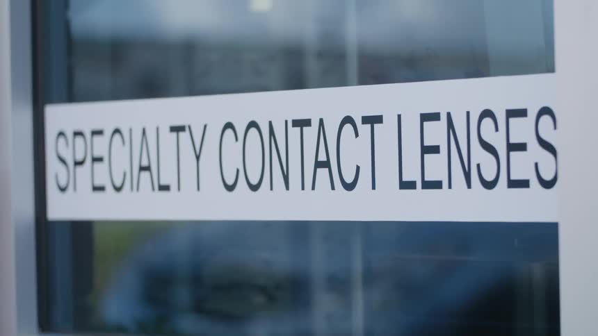 Glass door with text from a contact lens store