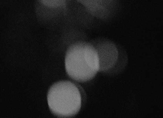 Out of focus footage of bright sparks caught on vintage film