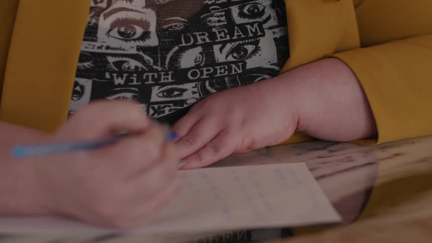 Portrait of a woman with prescription glasses writing