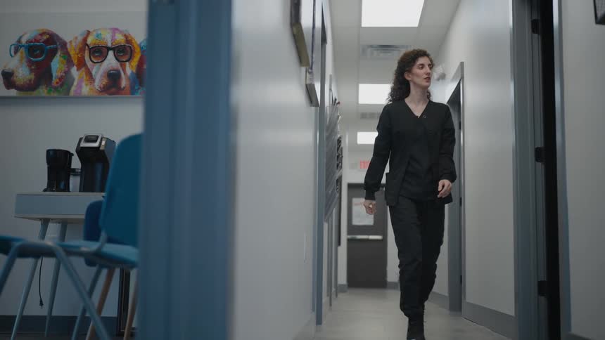 Woman walks down the hallway of a sterile building