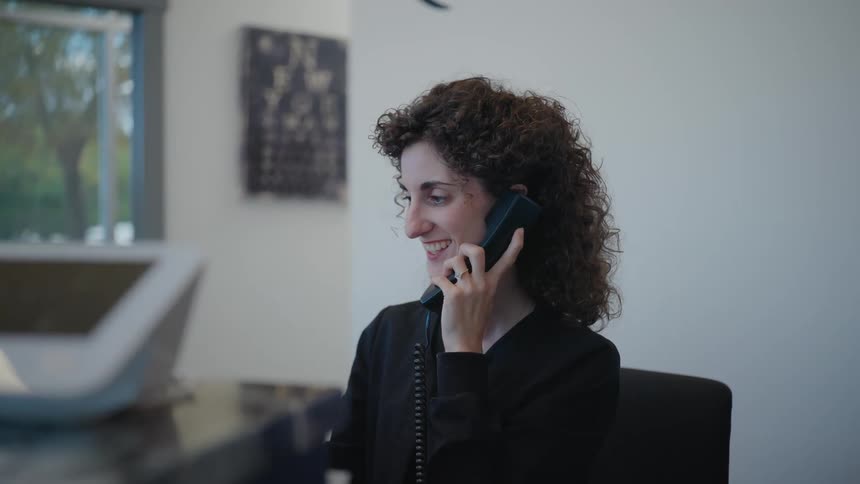 Woman having a phone call in the office