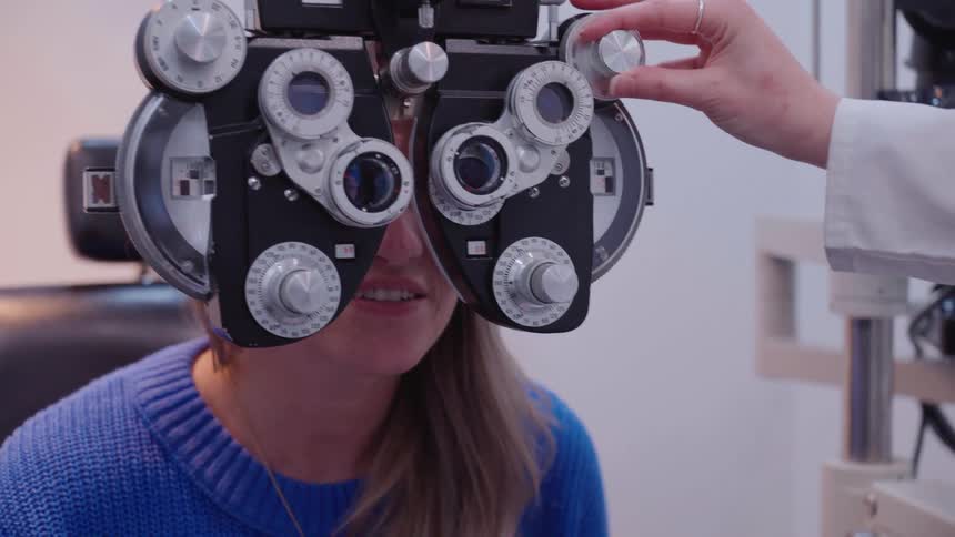 A person undergoing an eye examination with a phoropter