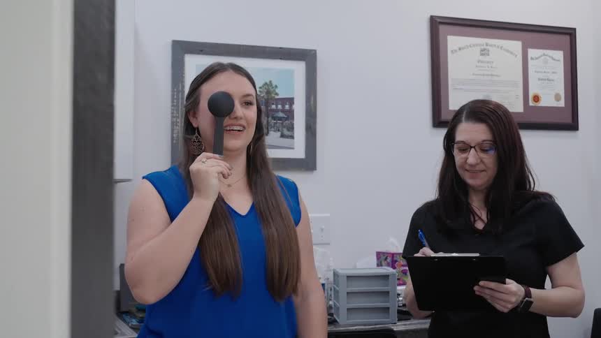 An ophthalmologist gives a patient a simple eye test