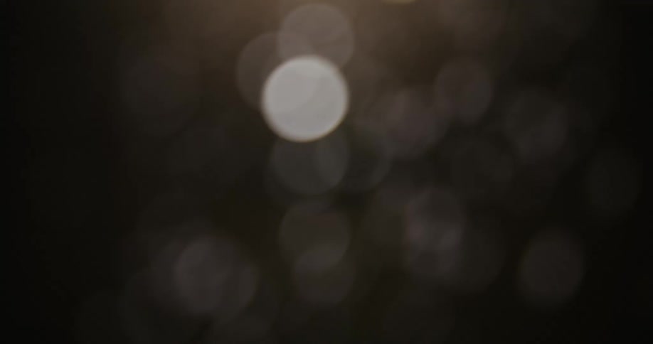 Out of focus dim sparks at night