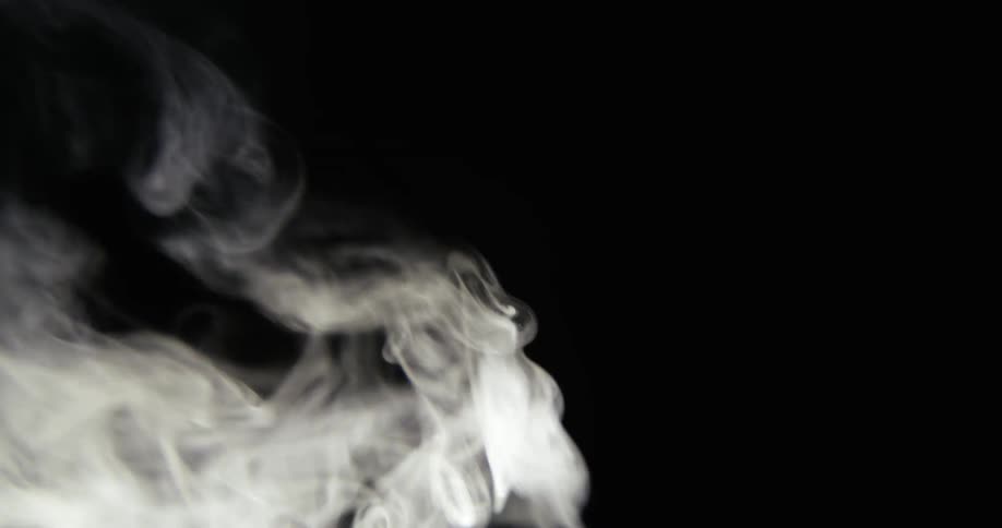 White smoke rises against a dark background