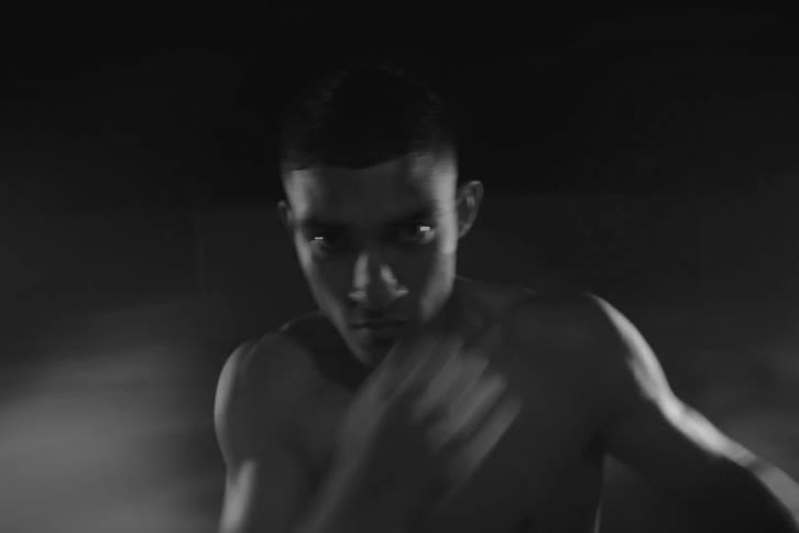 Portrait of a man without a shirt throwing boxing punches