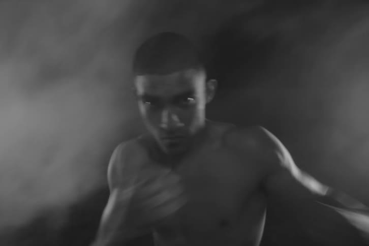A man boxing while surrounded by fog