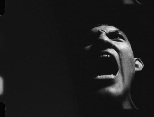Close up of a strong shirtless man screaming caught on vintage film